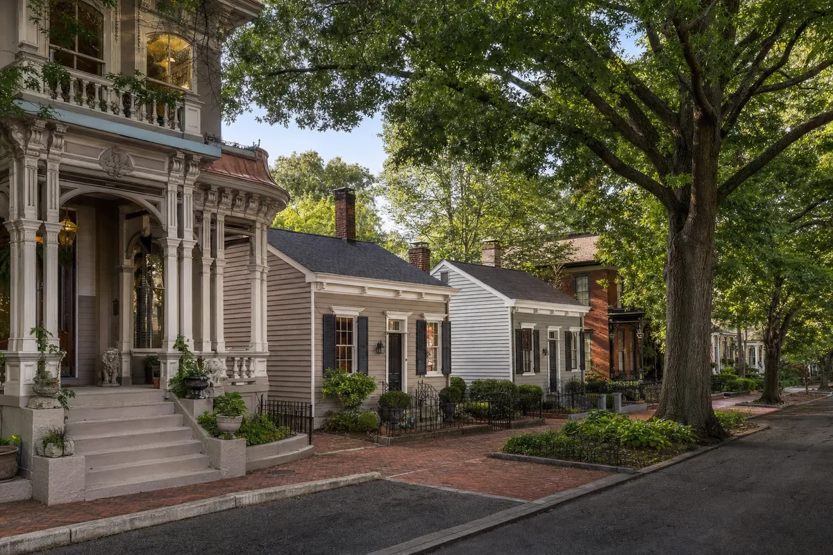 Historic Victorian mansion and shotgun houses on a tree-lined street in the Clifton neighborhood of Louisville, Kentucky