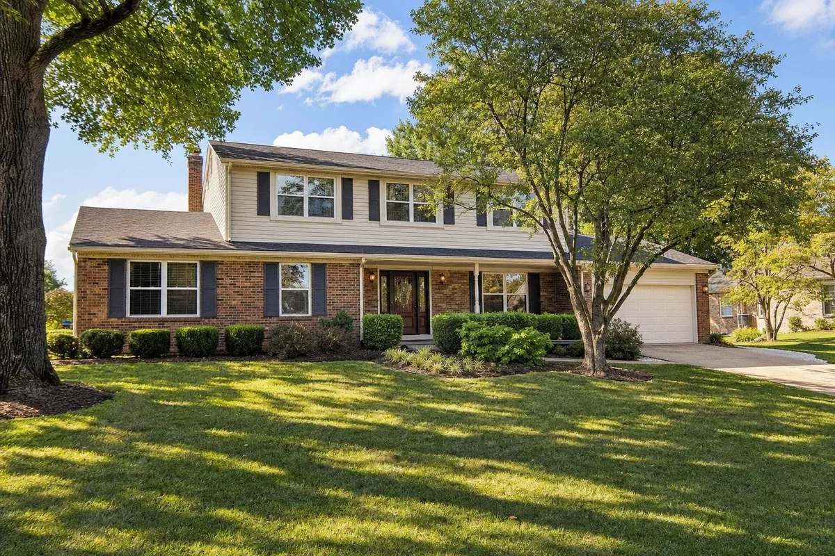 Established two-story brick home on a tree-lined street in Jeffersontown, Kentucky